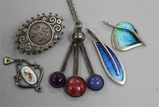 A Charles Horner pendant, two other silver and enamel pendants, a Scottish silver brooch and one other